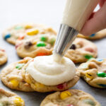 icing being piped onto a cookie.