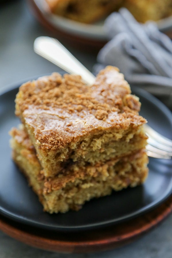 close-up shot of two slices of pumpkin spice cake on a plate.