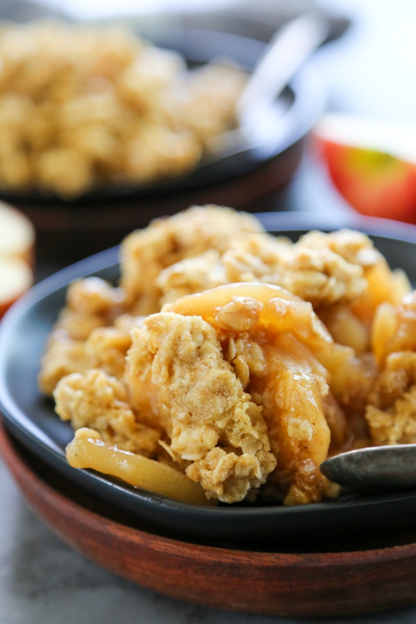 close-up shot of a serving of fruit crisp on a plate.