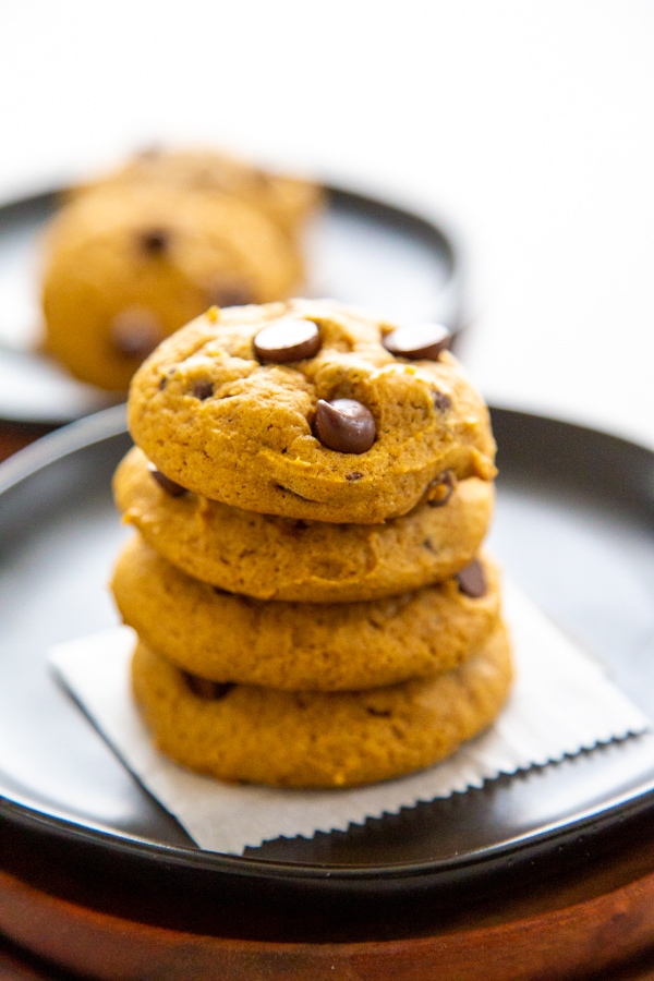 a stack of four pumpkin chocolate chip cookies.