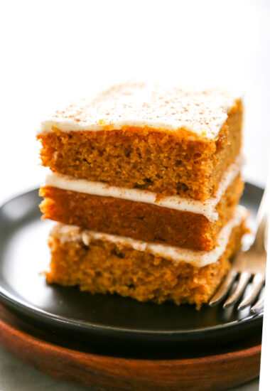 three stacked pumpkin bars with cream cheese frosting.