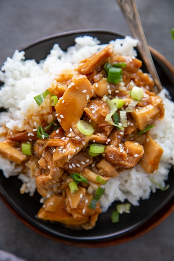 overhead photo of a plate of orange chicken with rice.