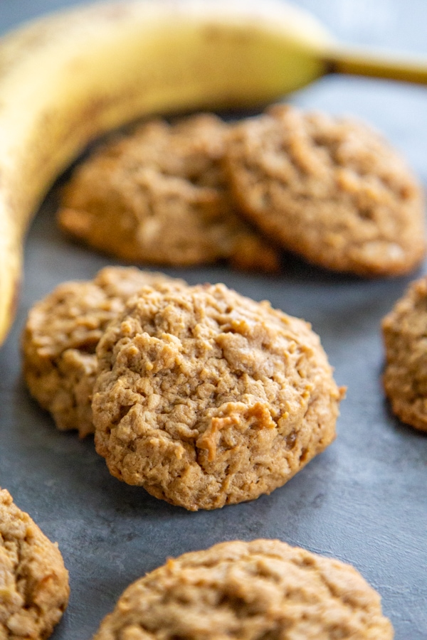 cookies on a work surface with a banana in the background.