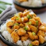 orange chicken on a plate with rice.