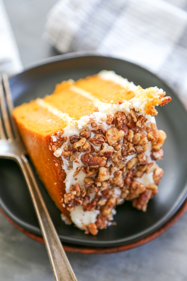  a close up shot showing the walnut coating on a slice of cake.