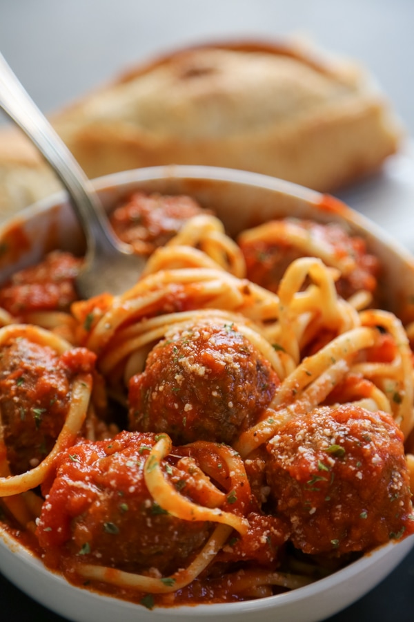 a close-up shot of a bowl of spaghetti and meatballs.