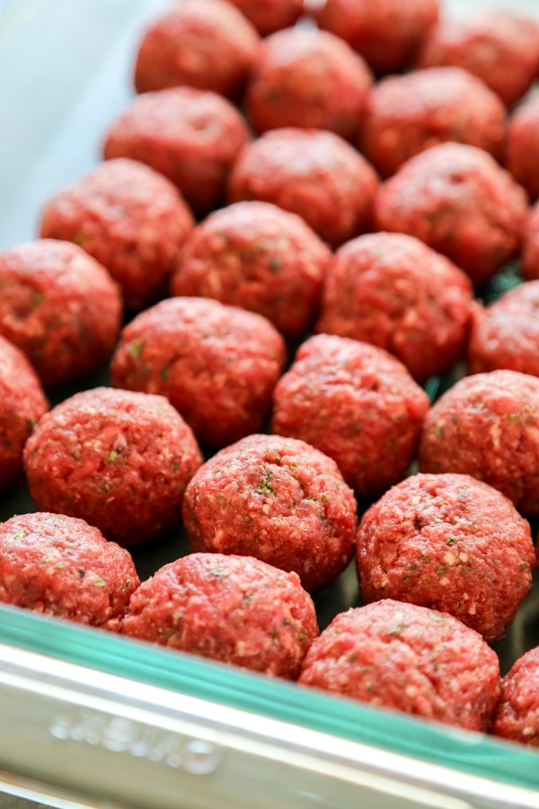 raw meatballs in a baking dish.