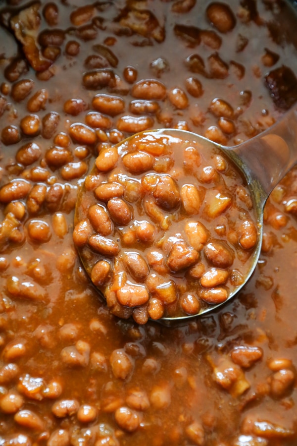 slow cooker baked beans with laddle.