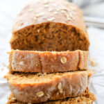 close up shot of a sliced loaf of oatmeal bread.