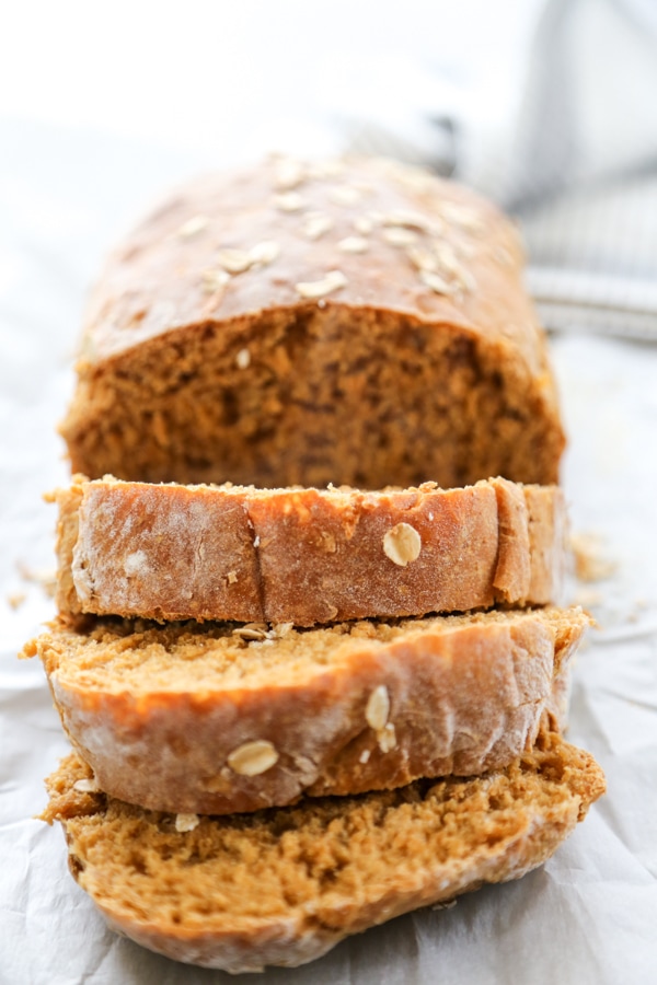 close up shot of a sliced loaf of oatmeal bread.