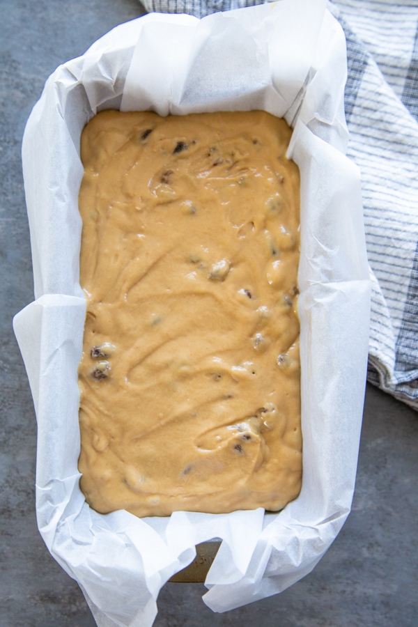 the bread batter in a baking pan lined with parchment paper.