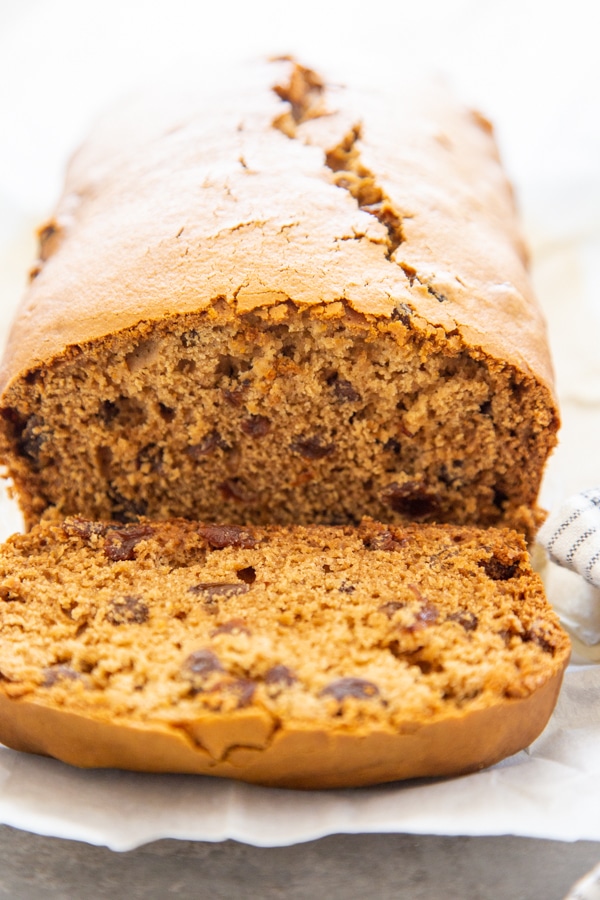 a loaf of brown bread with a slice cut off.