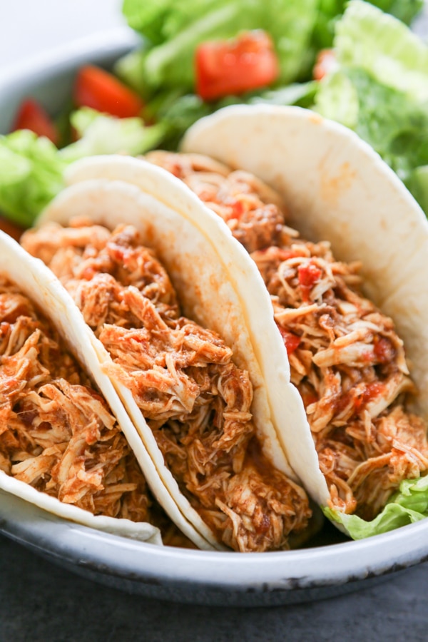 close-up shot of three chicken tacos.