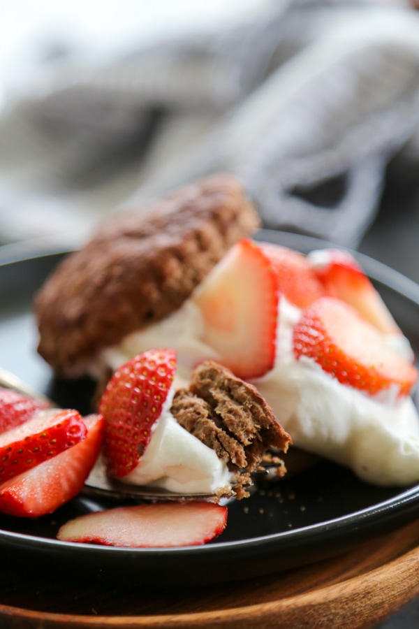 a piece of chocolate strawberry shortcake on a plate with a fork,