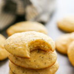 a stack of cookies with a bite taken out of the top one.