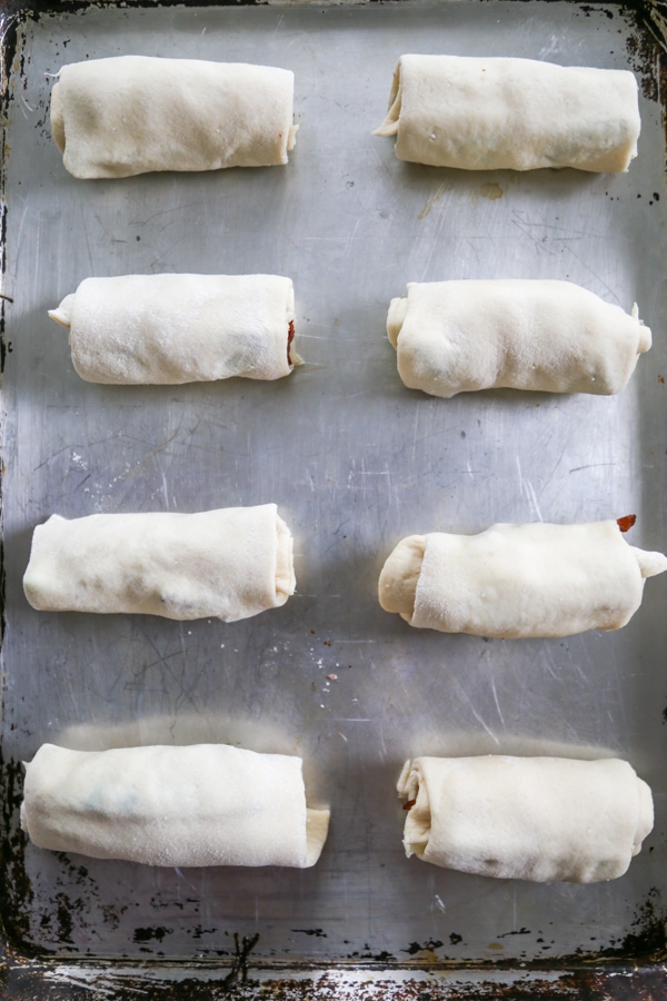 the rolled breadsticks on a baking sheet ready to be baked.