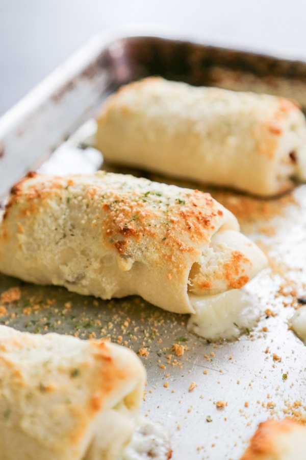 baked stuffed breadsticks on a baking sheet.