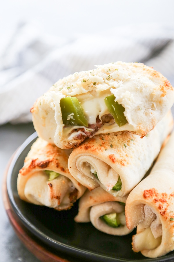 a stack of breadsticks on a plate.