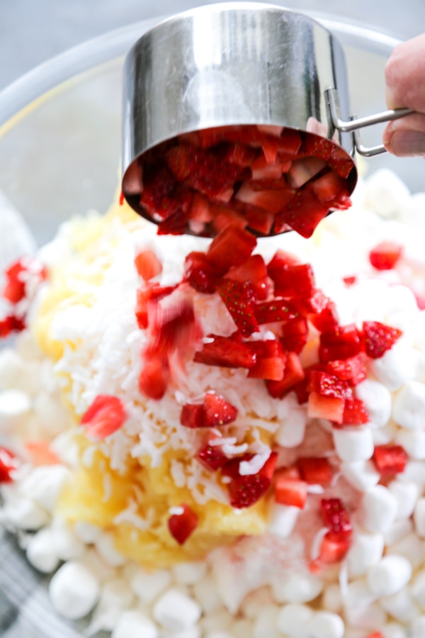 chopped strawberries being poured into the bowl.