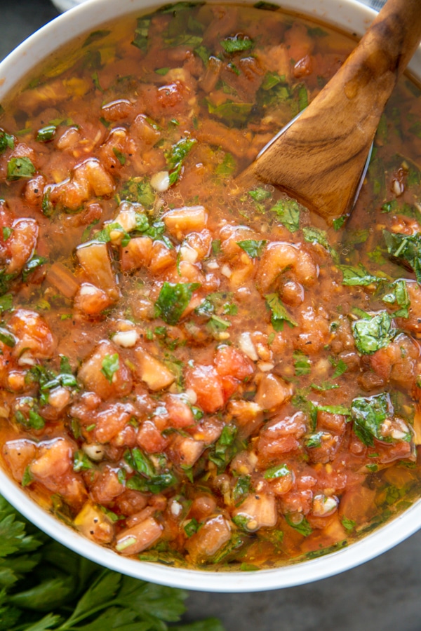 Margherita sauce overview shot in white bowl and wooden serving spoon