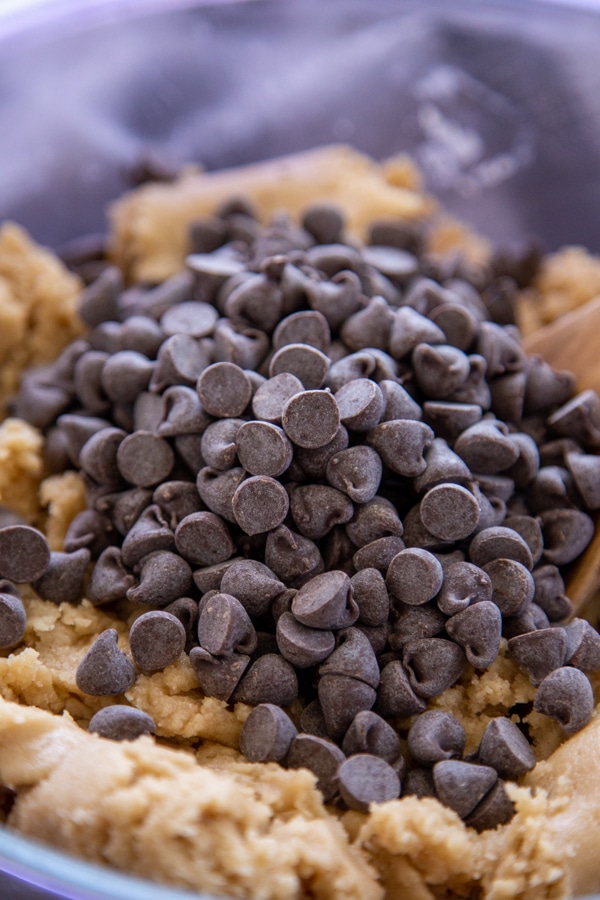 mixing bowl with cookie batter and chocolate chips on top