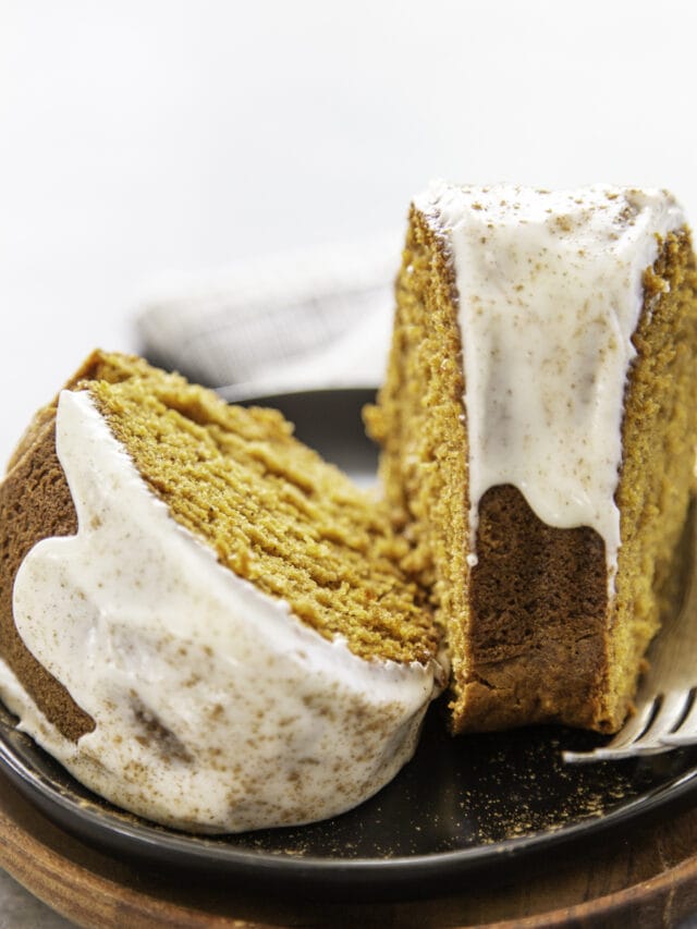 two pieces of cake with fork on black plate