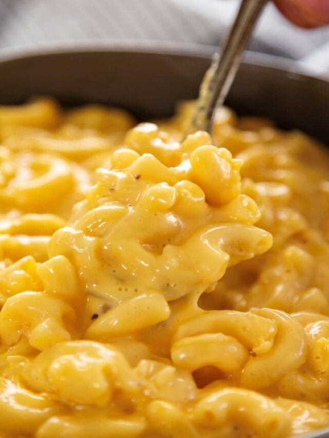 spoon in a bowl of mac and cheese