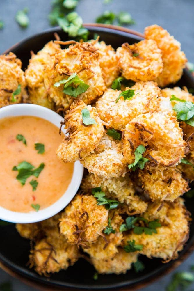 overhead shot coconut shrimp on plate with sauce