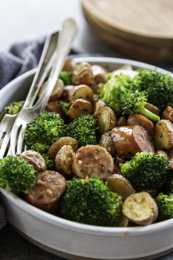 bowl of sausages, broccoli and potatoes