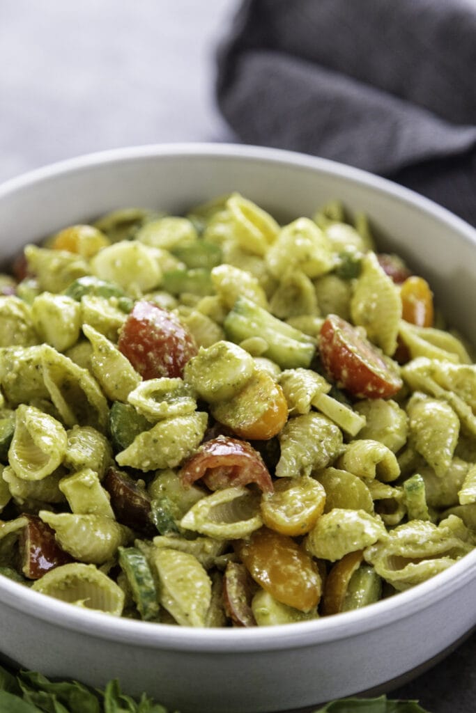 bowl of pesto pasta salad with tomatoes