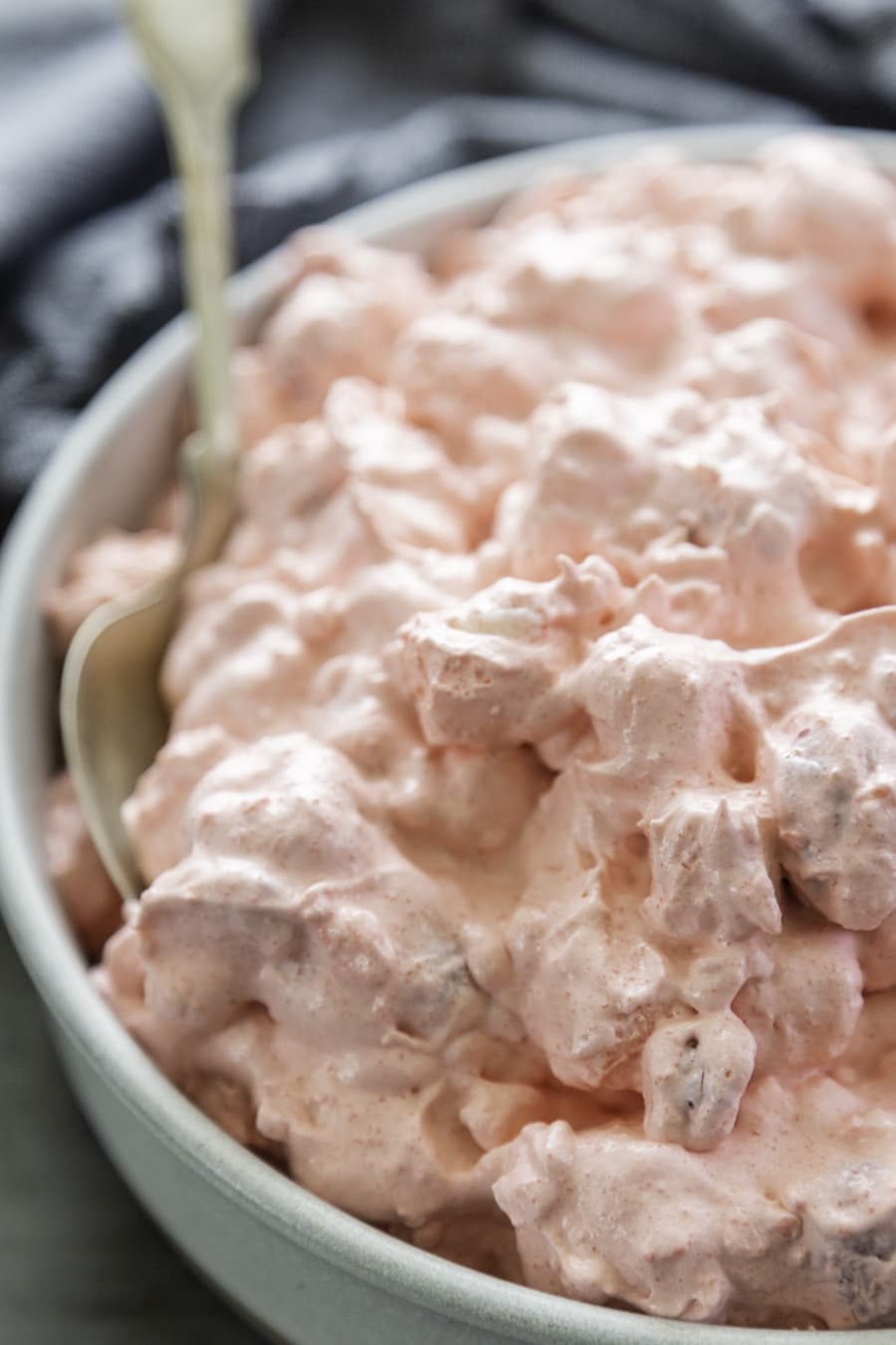 close up shot of raspberry fluff salad in bowl