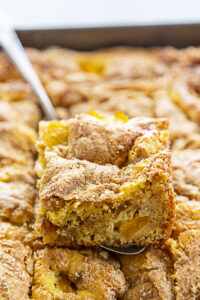 peach coffee cake piece in pan