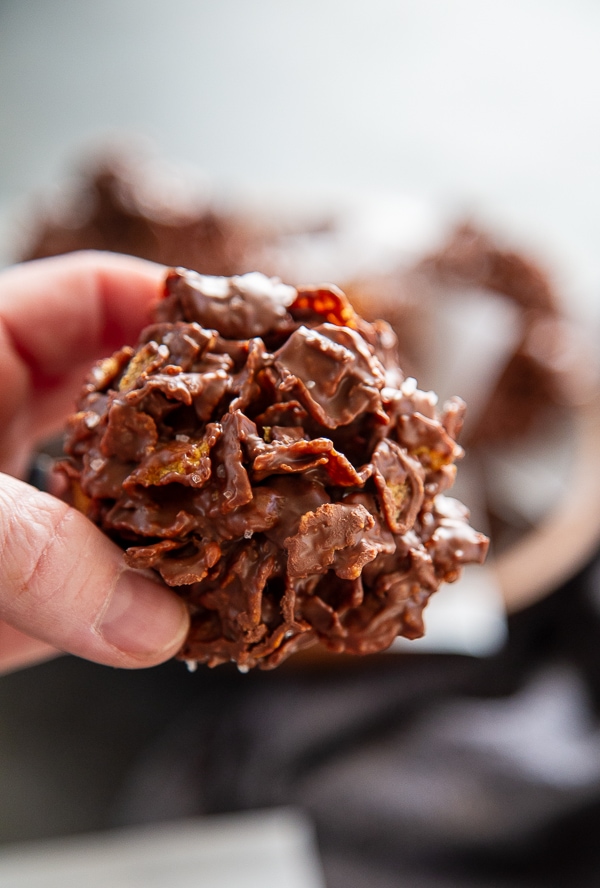 close-up shot hand holding a no bake chocolate cornflake cookie