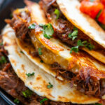 plated cheesy shredded beef tacos