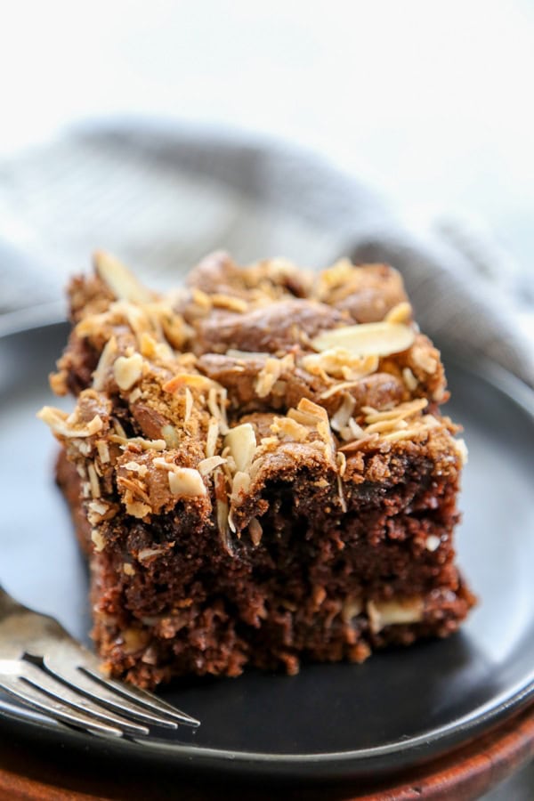 chocolate coffee cake piece on black plate