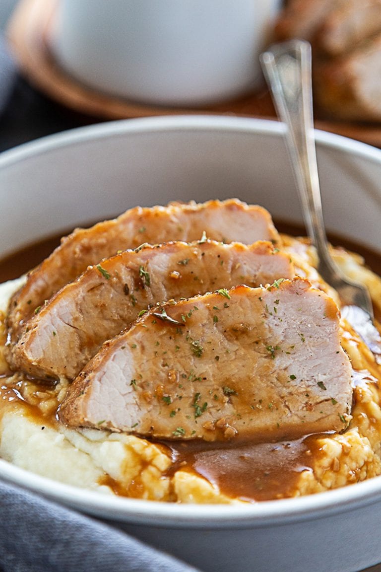 pork tenderloin in bowl with gravy and mashed potatoes