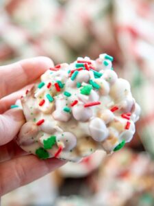 hand holding white chocolate peanut cluster