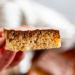 hand holding a collage image of Scotcheroos Rice Krispie treat
