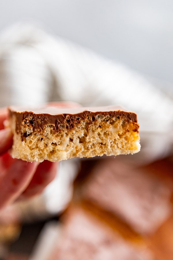 hand holding a collage image of Scotcheroos Rice Krispie treat