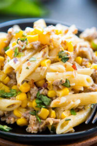 close up shot of creamy sausage and corn pasta