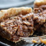 2 slices of chocolate pecan pie with bite take out