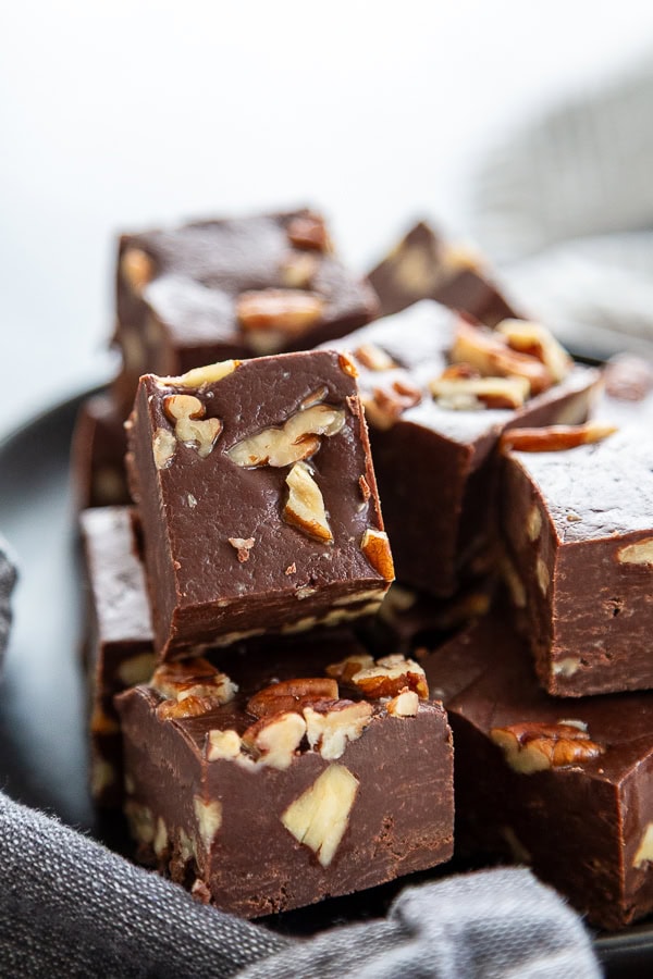stack of fudge with pecans on plate