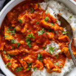 overhead shot tikka masala with white rice and cilantro in bowl