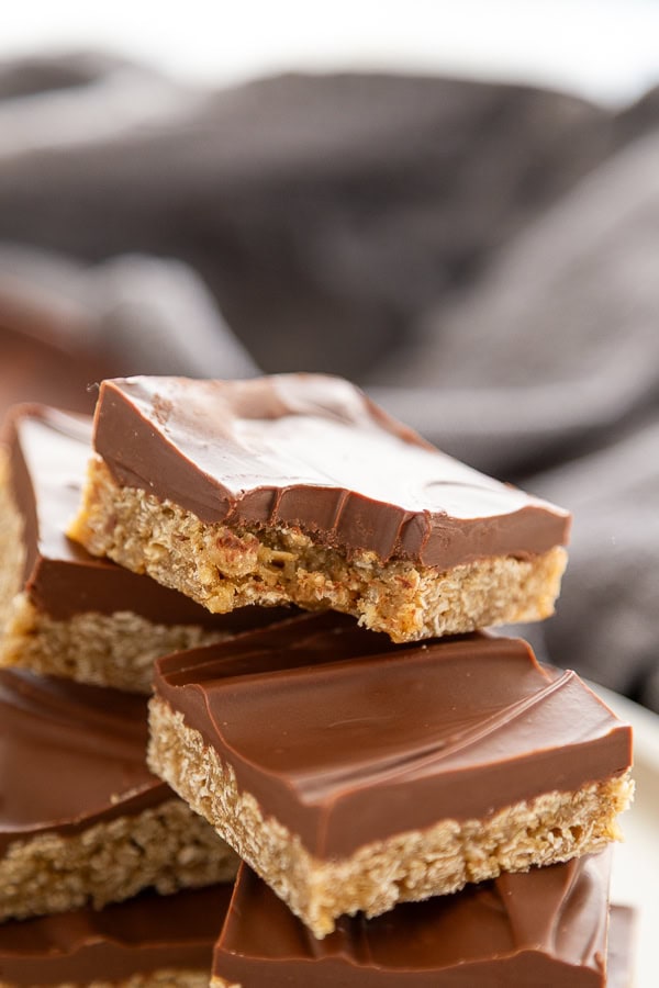 stack of oatmeal peanut butter chocolate bars with a bite out of one bar