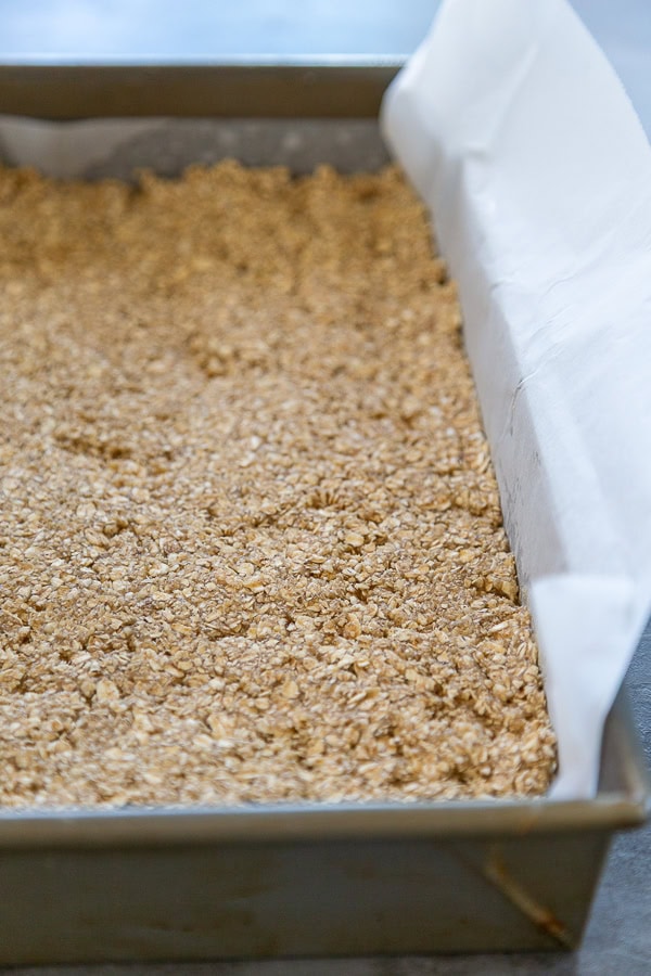 oat mixture pressed into 9x13 pan with parchment paper