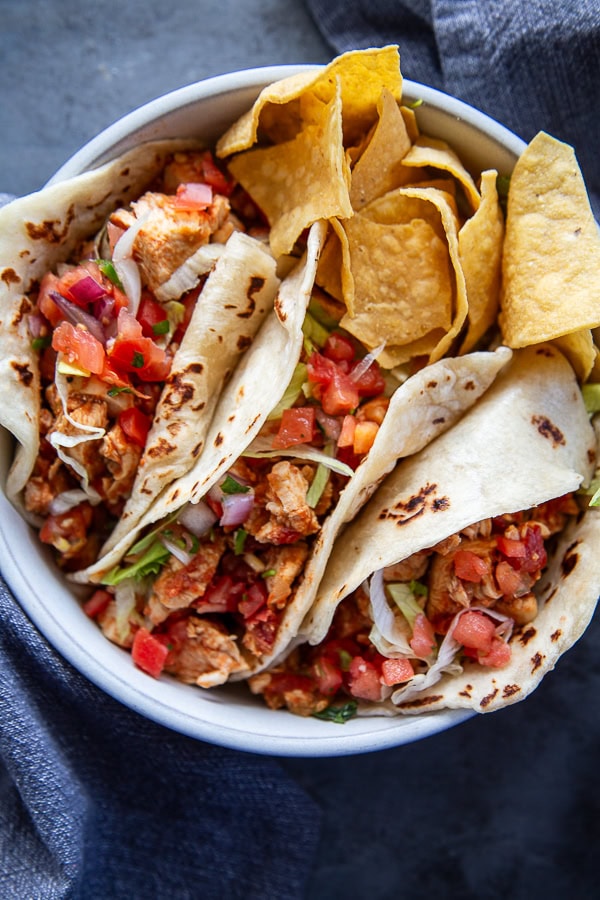 overhead shot soft chicken tacos with chips