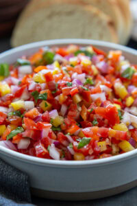 close up shot of tomato pepper bruschetta in bowl