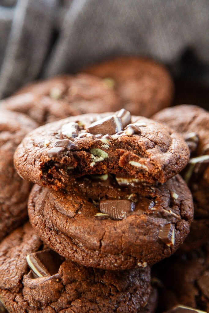 stack of chocolate andes mint cookies one with a bite out of it