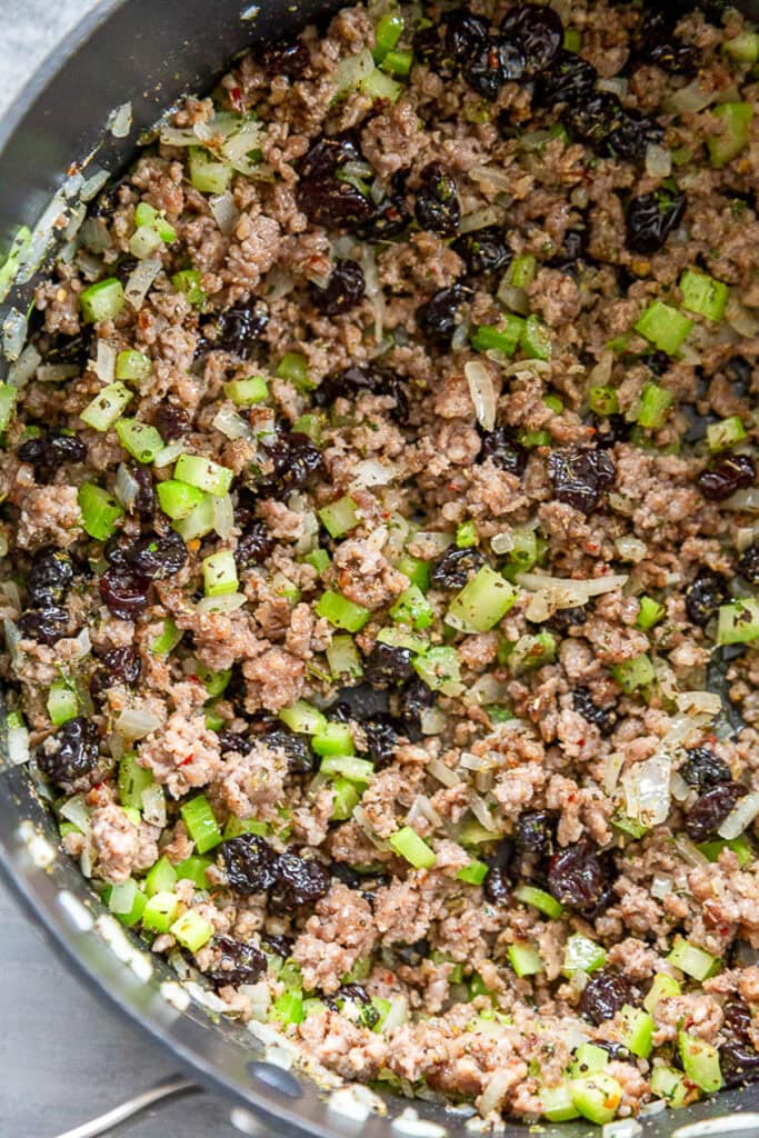 overhead shot pan of celery and onions and sausage