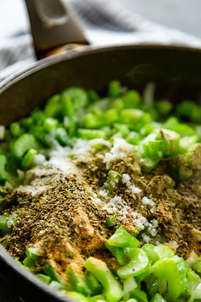 celery and onions in pan with peppers